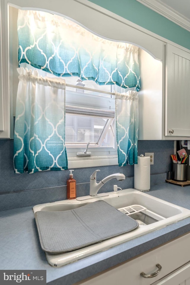 46 Jefferson St, Weatherly, PA 18255 - detailed view of a sink, white cabinetry, and ornamental molding