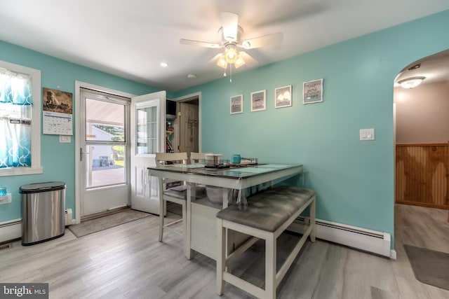 46 Jefferson St, Weatherly, PA 18255 - dining area with baseboard heating, arched walkways, light wood-type flooring, and ceiling fan
