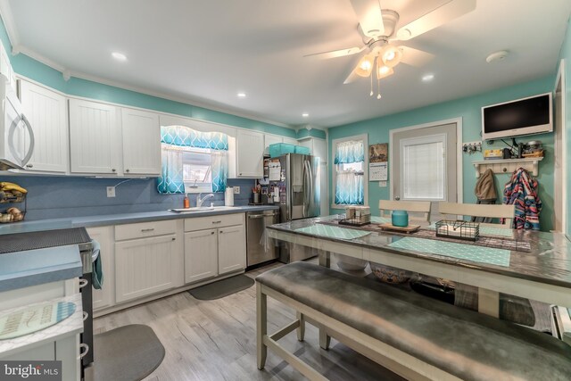 46 Jefferson St, Weatherly, PA 18255 - kitchen featuring appliances with stainless steel finishes, a sink, light wood-type flooring, white cabinetry, and a ceiling fan