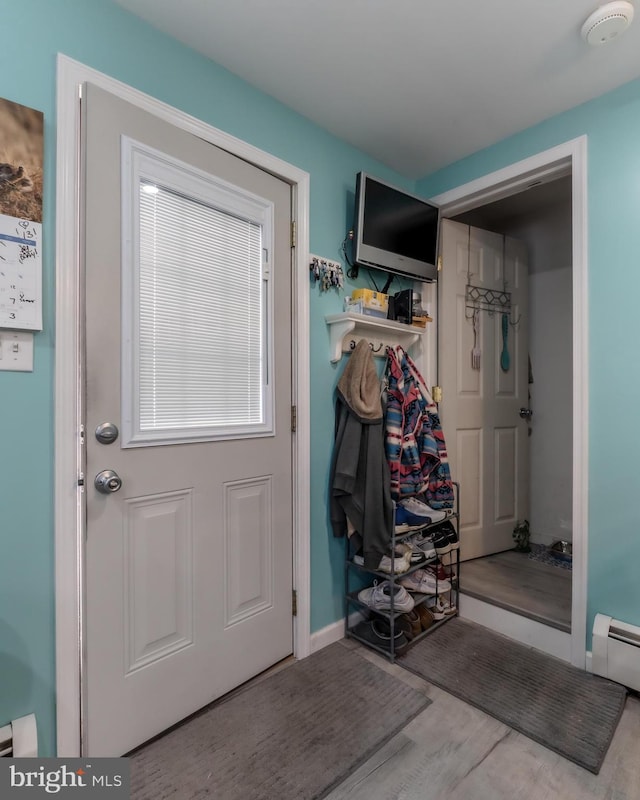 46 Jefferson St, Weatherly, PA 18255 - doorway to outside with wood finished floors, a baseboard radiator, and baseboards