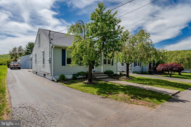 46 Jefferson St, Weatherly, PA 18255 - obstructed view of property featuring a front lawn and roof with shingles