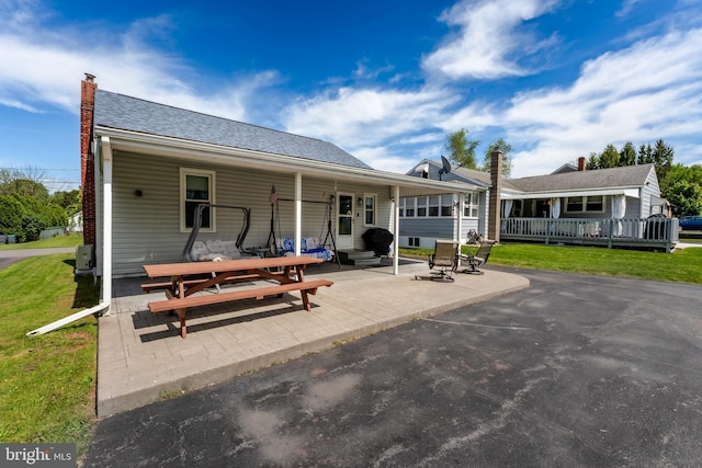 46 Jefferson St, Weatherly, PA 18255 - rear view of house featuring a yard, a chimney, and a patio area