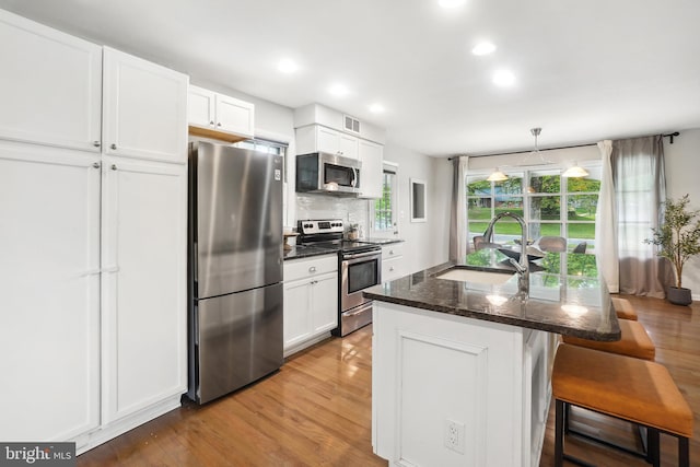 900 W Nolcrest Dr, Silver Spring, MD 20903 - kitchen featuring stainless steel appliances, a sink, light wood-style flooring, white cabinets, and recessed lighting