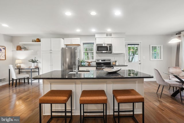 900 W Nolcrest Dr, Silver Spring, MD 20903 - kitchen featuring stainless steel appliances, a sink, white cabinetry, a breakfast bar area, and recessed lighting