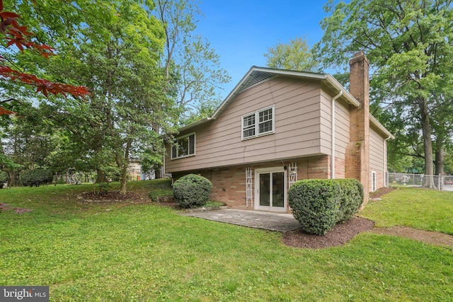 900 W Nolcrest Dr, Silver Spring, MD 20903 - rear view of property featuring a chimney, a patio area, and brick siding