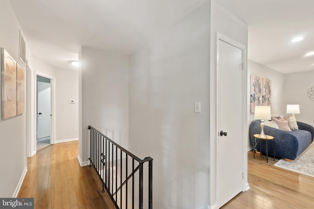 900 W Nolcrest Dr, Silver Spring, MD 20903 - hall with an upstairs landing, wood-type flooring, baseboards, and recessed lighting