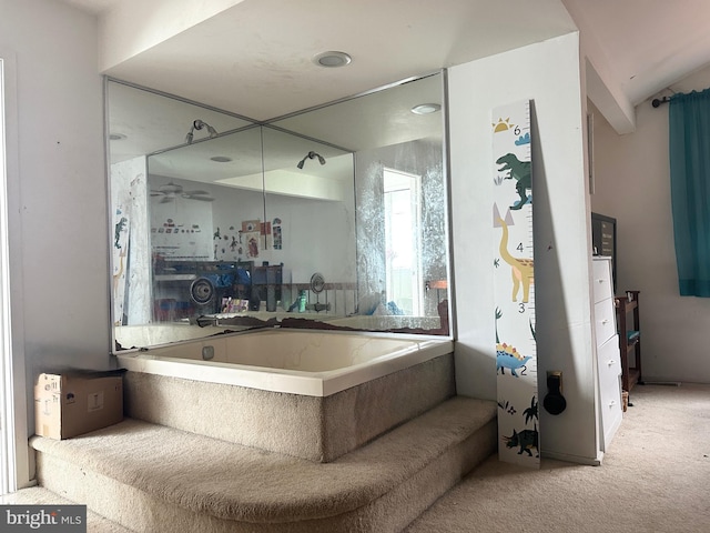 bathroom with a garden tub and a ceiling fan
