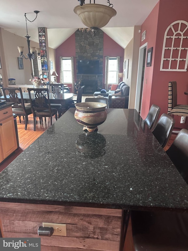 131 Winding Way, Bangor, PA 18013 - dining room with lofted ceiling, wood finished floors, plenty of natural light, a chandelier, and a fireplace