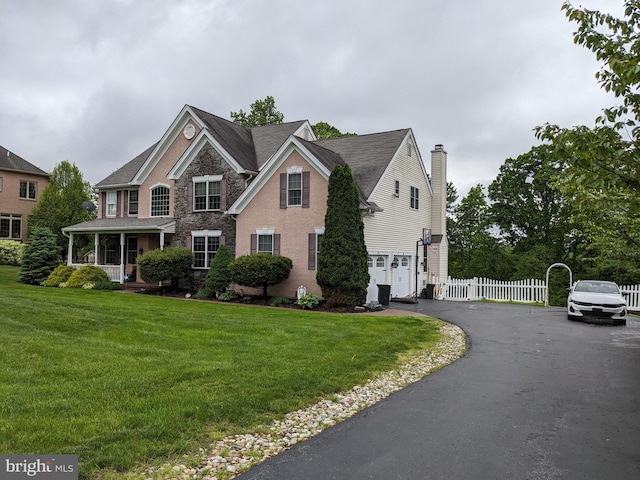 131 Winding Way, Bangor, PA 18013 - view of front of home with an attached garage, a porch, asphalt driveway, and stone siding