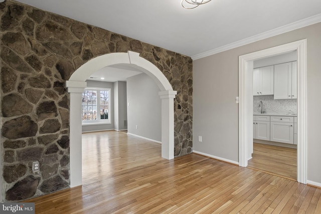 941 Sherwood Ct, Sterling, VA 20164 - unfurnished room featuring arched walkways, light wood finished floors, crown molding, and baseboards