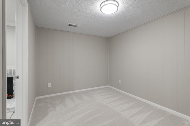 941 Sherwood Ct, Sterling, VA 20164 - spare room with a fireplace, a textured ceiling, and carpet flooring