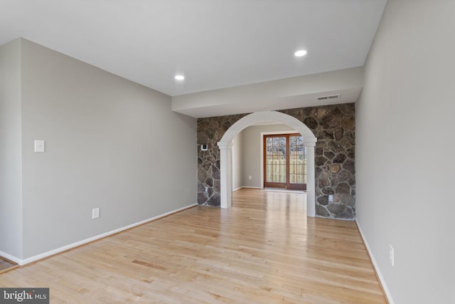 941 Sherwood Ct, Sterling, VA 20164 - unfurnished living room featuring arched walkways, wood finished floors, and baseboards