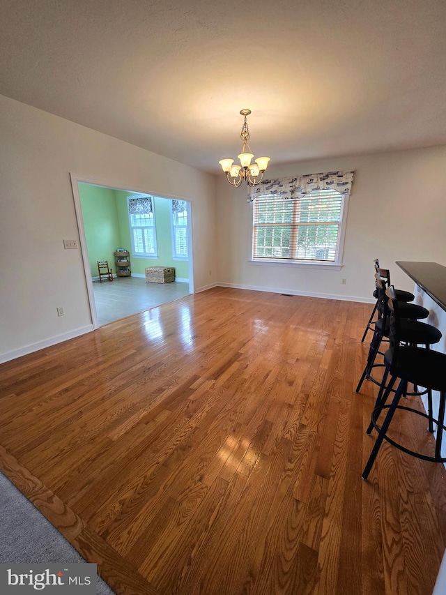 7677 Green Ridge Ln, Abbottstown, PA 17301 - dining area featuring a chandelier, wood finished floors, and baseboards