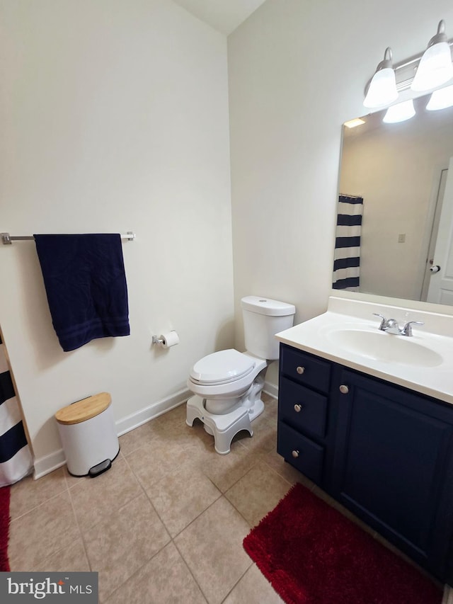 7677 Green Ridge Ln, Abbottstown, PA 17301 - bathroom with toilet, vanity, tile patterned flooring, and baseboards