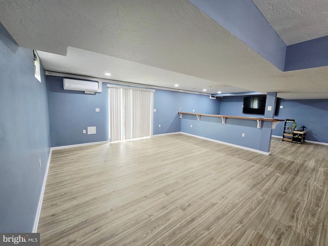 7677 Green Ridge Ln, Abbottstown, PA 17301 - finished basement with an AC wall unit, wood finished floors, a textured ceiling, baseboards, and recessed lighting