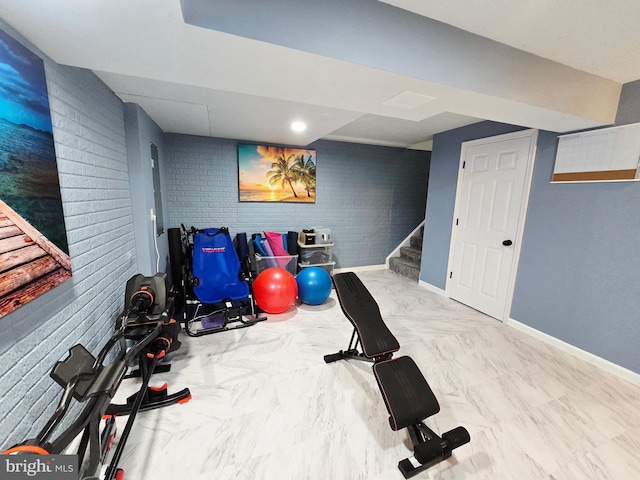 7677 Green Ridge Ln, Abbottstown, PA 17301 - exercise room featuring baseboards, brick wall, and marble look tile flooring
