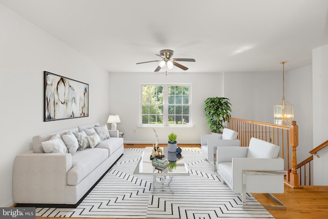 1118 Ashby St, Front Royal, VA 22630 - living room featuring wood finished floors, a ceiling fan, a chandelier, and baseboards