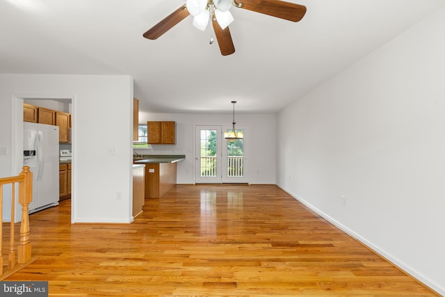 1118 Ashby St, Front Royal, VA 22630 - unfurnished living room with light wood-style flooring, a ceiling fan, and baseboards