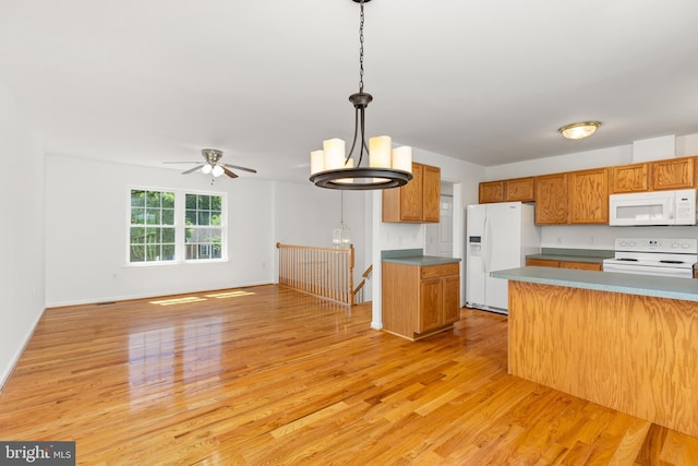 1118 Ashby St, Front Royal, VA 22630 - kitchen featuring white appliances, light wood-style floors, pendant lighting, and brown cabinets