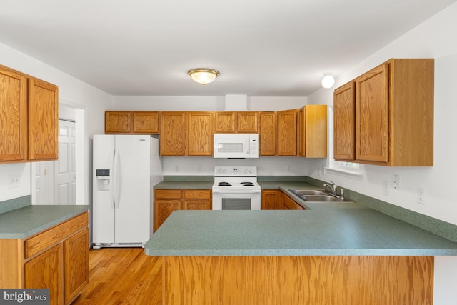 1118 Ashby St, Front Royal, VA 22630 - kitchen with white appliances, a sink, a peninsula, light wood-style flooring, and brown cabinets