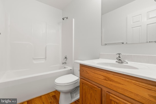 1118 Ashby St, Front Royal, VA 22630 - bathroom with toilet, vanity, bathtub / shower combination, and wood finished floors