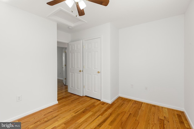 1118 Ashby St, Front Royal, VA 22630 - unfurnished bedroom with light wood-type flooring, baseboards, a ceiling fan, and attic access
