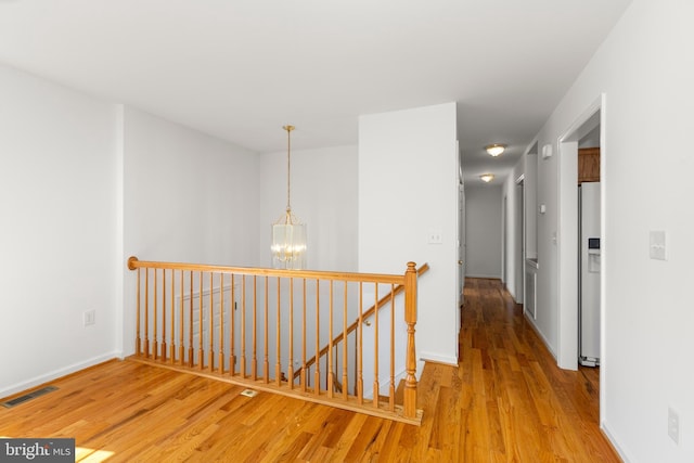 1118 Ashby St, Front Royal, VA 22630 - hall with an upstairs landing, a chandelier, wood finished floors, and baseboards