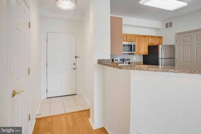 1530 Spring Gate Dr Unit 9308, Mclean, VA 22102 - kitchen with appliances with stainless steel finishes, light stone counters, light wood finished floors, and baseboards