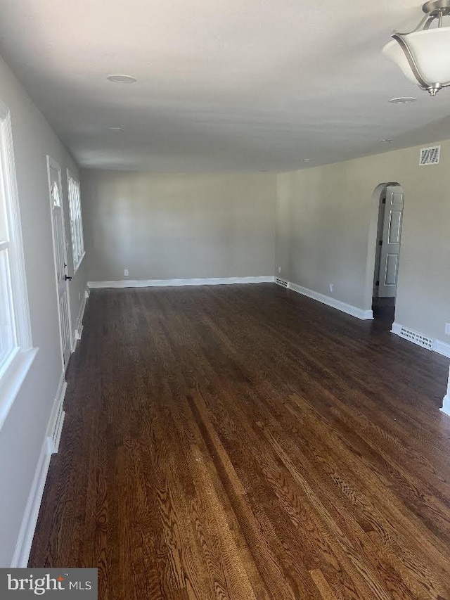 20 Goeke Dr, Hamilton, NJ 08610 - empty room with dark wood-type flooring, arched walkways, and baseboards