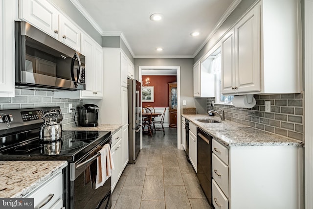 10 Garrett Rd, Wilmington, DE 19809 - kitchen with black appliances, a sink, white cabinetry, recessed lighting, and crown molding