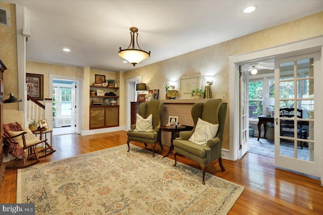 61 Park Rd, Reading, PA 19609 - living area featuring built in shelves, wood finished floors, a ceiling fan, stairway, and ornamental molding