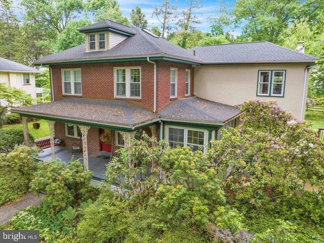 61 Park Rd, Reading, PA 19609 - view of front of home featuring brick siding, a patio area, and a chimney