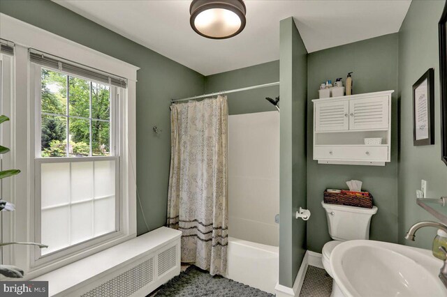 61 Park Rd, Reading, PA 19609 - bathroom featuring radiator heating unit, shower / bath combination with curtain, a sink, toilet, and baseboards