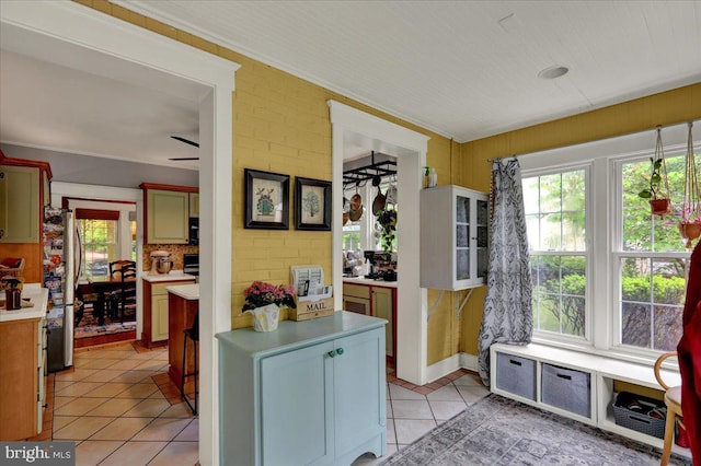 61 Park Rd, Reading, PA 19609 - kitchen featuring freestanding refrigerator, healthy amount of natural light, light tile patterned floors, light countertops, and ornamental molding