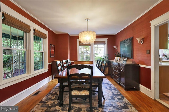 61 Park Rd, Reading, PA 19609 - dining area with wood finished floors, a chandelier, baseboards, and ornamental molding