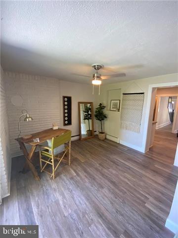 31 E Goepp St, Bethlehem, PA 18018 - dining space with wood finished floors, a textured ceiling, ceiling fan, and baseboards