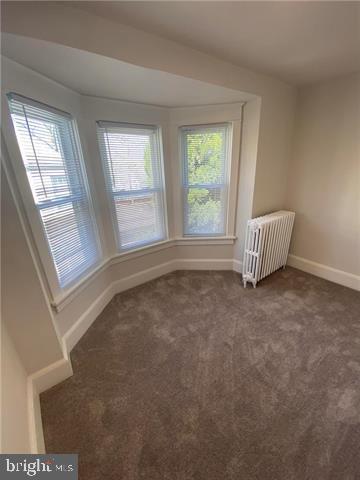 31 E Goepp St, Bethlehem, PA 18018 - empty room with radiator, carpet flooring, and baseboards