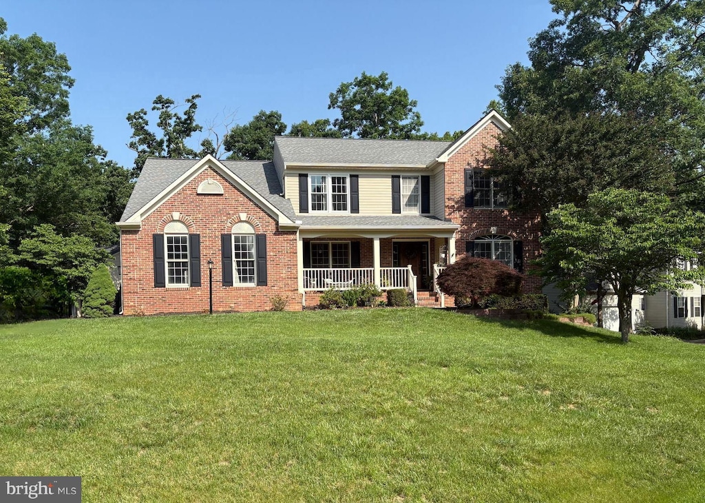 10101 Westover Ct, Fredericksburg, VA 22408 - view of front of home with covered porch, a front yard, brick siding, and a shingled roof