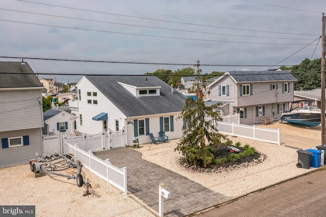 887 Beach Haven W Blvd, Manahawkin, NJ 08050 - view of front of home with a residential view, a fenced backyard, and roof with shingles