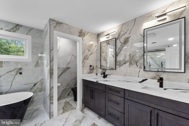 2761 Ebbvale Rd, Manchester, MD 21102 - full bathroom featuring tile walls, marble tiled floors, a freestanding bath, double vanity, and toilet