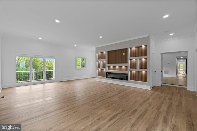 2761 Ebbvale Rd, Manchester, MD 21102 - unfurnished living room with crown molding, light wood-style floors, baseboards, recessed lighting, and a glass covered fireplace