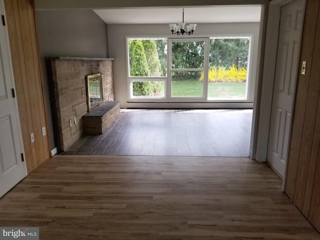 1320 Oak Ln, New Cumberland, PA 17070 - unfurnished living room featuring wood finished floors, a chandelier, and a glass covered fireplace