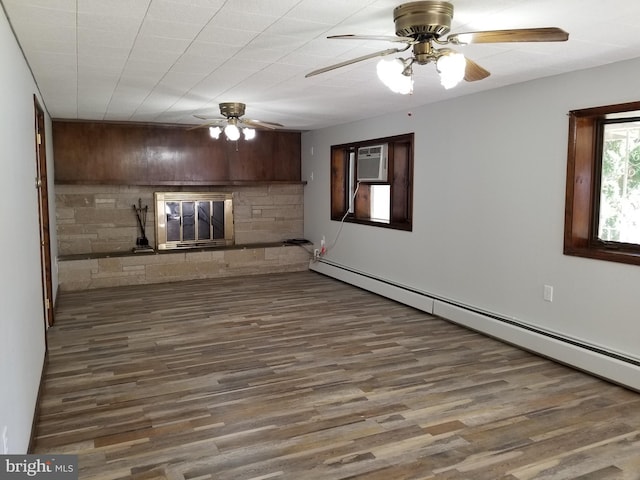 1320 Oak Ln, New Cumberland, PA 17070 - unfurnished living room with a glass covered fireplace, baseboard heating, ceiling fan, wood finished floors, and a wall mounted AC