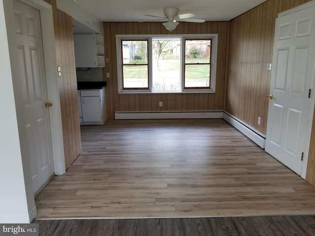 1320 Oak Ln, New Cumberland, PA 17070 - unfurnished dining area featuring ceiling fan, light wood-type flooring, and a baseboard radiator