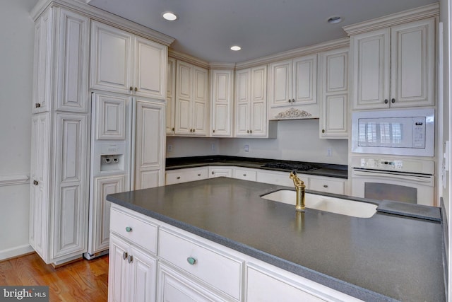 3609 Bradinton, Williamsburg, VA 23188 - kitchen with white appliances, a sink, dark countertops, light wood-style flooring, and recessed lighting
