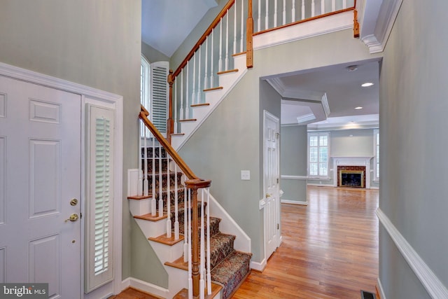 3609 Bradinton, Williamsburg, VA 23188 - entrance foyer with wood finished floors, a towering ceiling, baseboards, stairs, and a fireplace