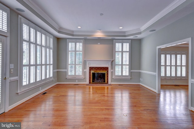 3609 Bradinton, Williamsburg, VA 23188 - unfurnished living room with a raised ceiling, plenty of natural light, wood finished floors, and ornamental molding