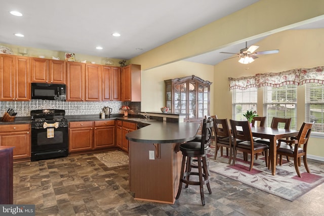 17365 Norland Way, Shrewsbury, PA 17361 - kitchen featuring black appliances, a peninsula, a sink, decorative backsplash, and dark countertops