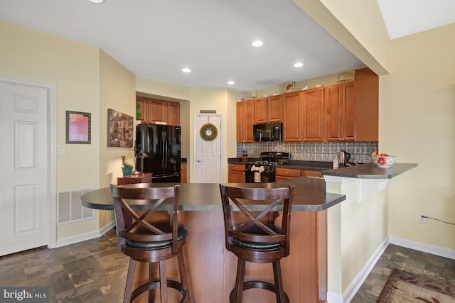 17365 Norland Way, Shrewsbury, PA 17361 - kitchen with black appliances, dark countertops, a peninsula, tasteful backsplash, and brown cabinetry
