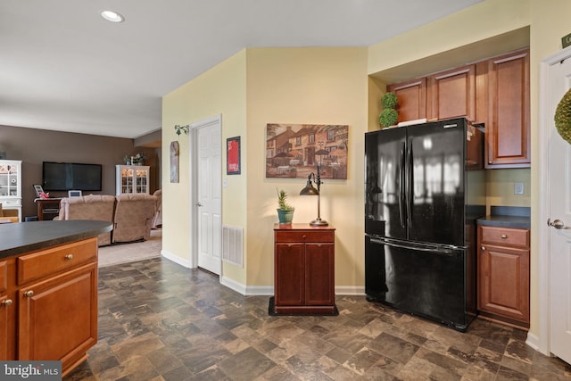 17365 Norland Way, Shrewsbury, PA 17361 - kitchen with freestanding refrigerator, dark countertops, dark stone finish floors, brown cabinetry, and recessed lighting